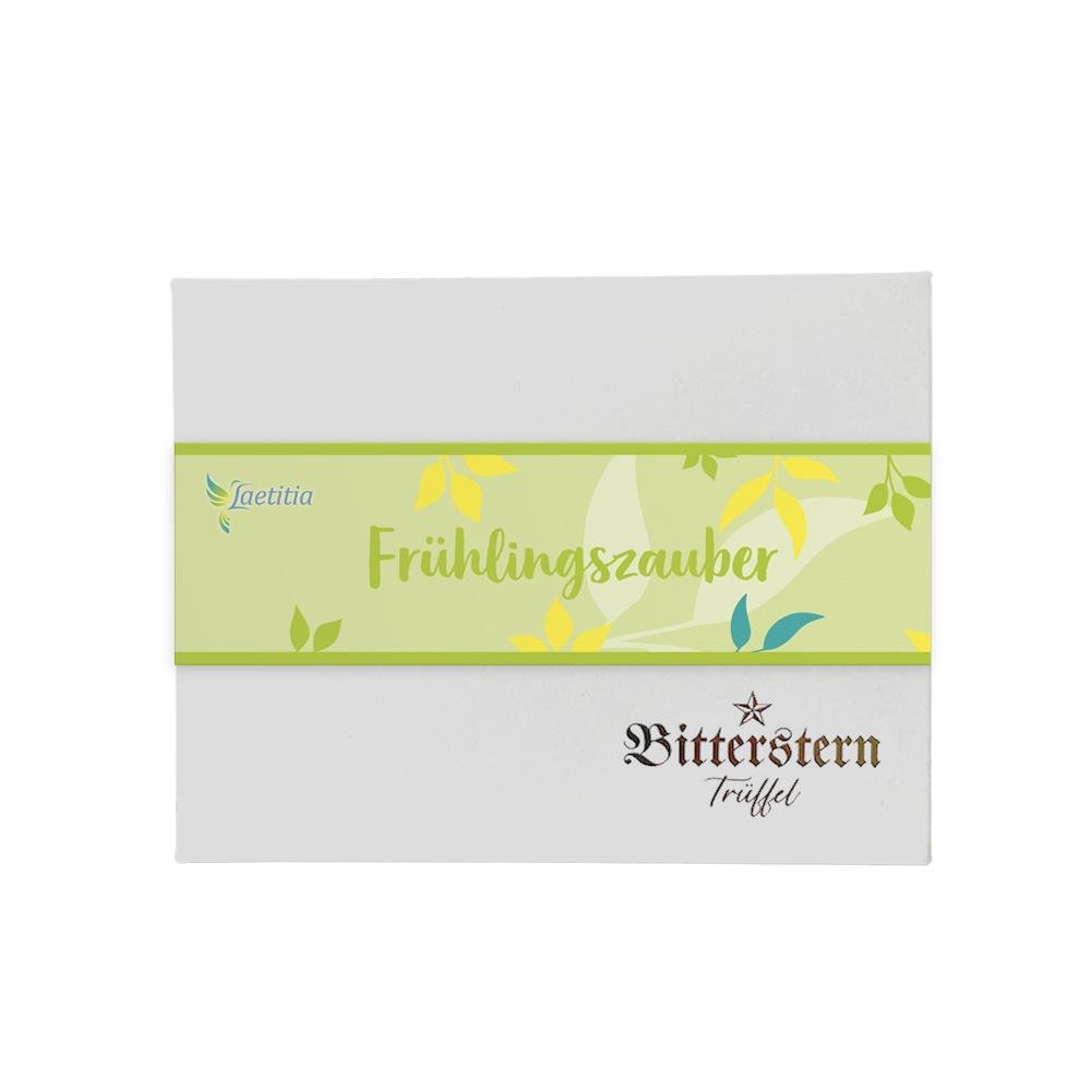 Verpackung der Original Bitterstern-Trüffel Frühlingsedition mit gelben und grünen Blättern auf hellgrünem Hintergrund.
