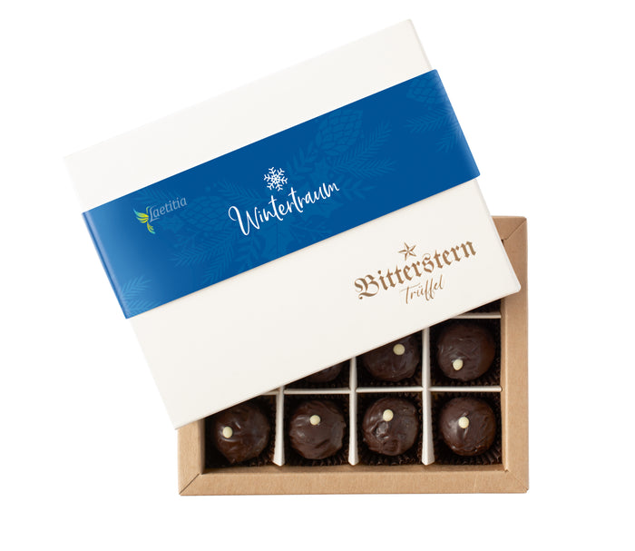 Offene Schachtel mit 12 Original Bitterstern-Trüffeln Winteredition, edle Pralinen mit dunkler Schokolade, elegant und zum Verschenken verpackt