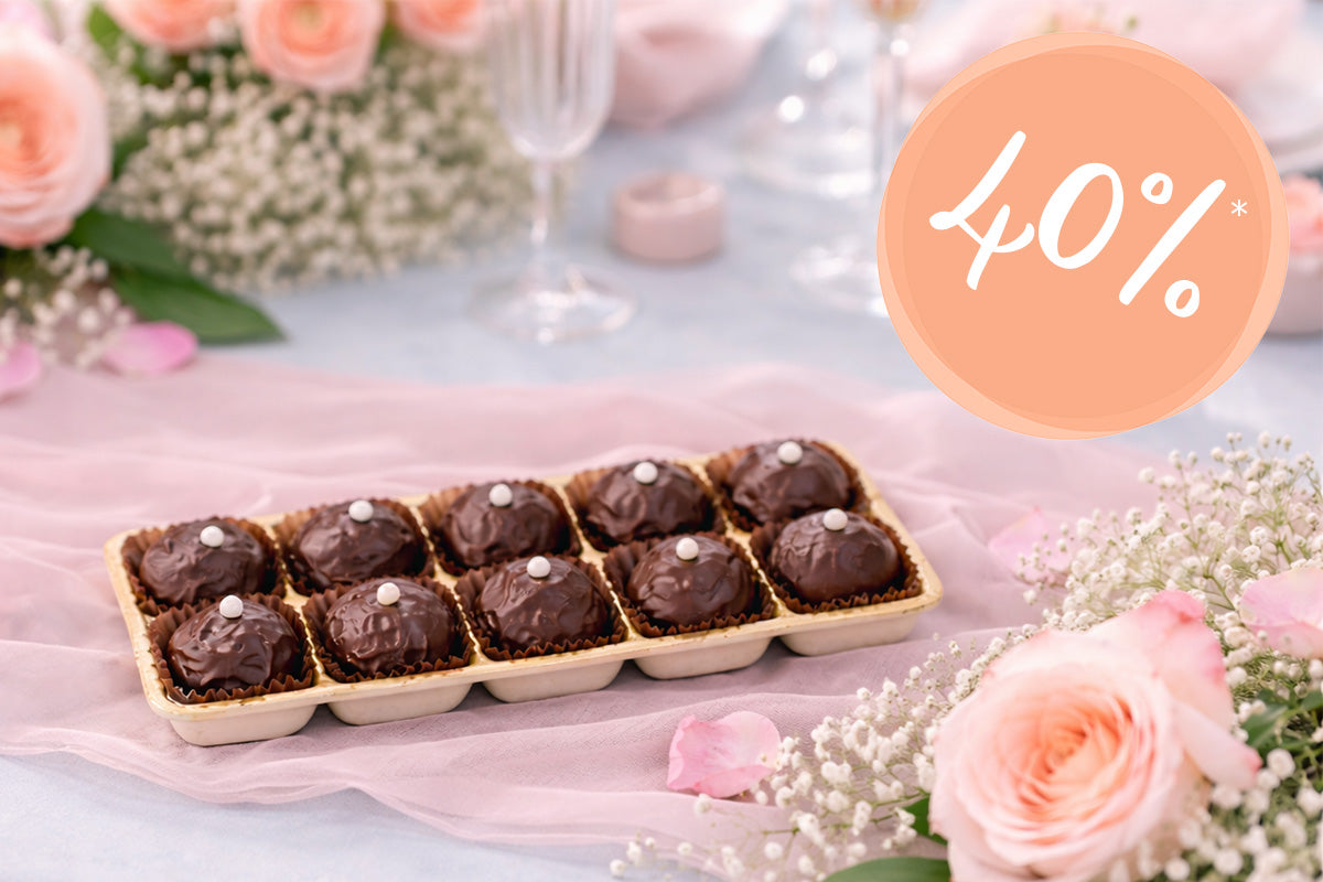 Schokoladentrüffel auf einem frühlingshaften gedeckten Tisch, rechts oben eine Bubble mit 40%.
